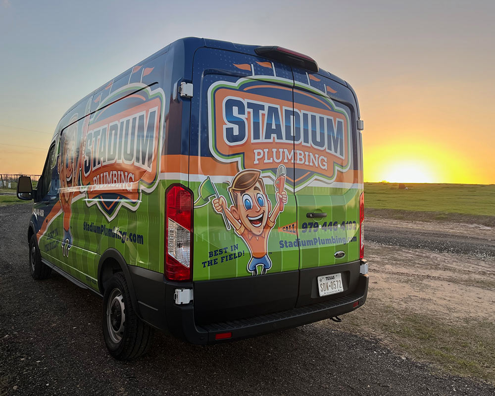plumbers company van at land with sunset on the background college station tx